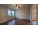 Spacious living room featuring hardwood floors, a ceiling fan, and natural light at 2668 Meadow St, Gastonia, NC 28056