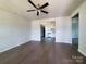 Open-concept living room with hardwood floors, bright white walls, and a view into the modern kitchen at 2668 Meadow St, Gastonia, NC 28056