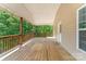 Inviting covered wooden back deck perfect for outdoor entertaining and relaxation at 159 Badin Lake Cir, New London, NC 28127