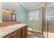 Bathroom featuring a modern vanity, mirror and walk-in shower with glass door at 159 Badin Lake Cir, New London, NC 28127