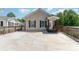 Attractive single-story home showcasing a front porch, dark shutters and a large concrete driveway at 159 Badin Lake Cir, New London, NC 28127