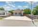 Cozy single-story home featuring a welcoming front porch and a large concrete driveway for ample parking at 159 Badin Lake Cir, New London, NC 28127