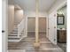 Hallway leads to a staircase and the living room and a full bathroom at 159 Badin Lake Cir, New London, NC 28127