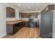 A spacious kitchen with stainless steel refrigerator and wood-look floors and cabinetry at 159 Badin Lake Cir, New London, NC 28127