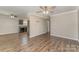 Open-concept living area showcasing dark wood floors and an adjacent kitchen with dark cabinets at 159 Badin Lake Cir, New London, NC 28127