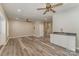 Living room with hardwood floors, a sink, and a ceiling fan and a view to the staircase at 159 Badin Lake Cir, New London, NC 28127