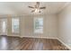 Bright living room features hardwood flooring and multiple windows for natural light at 159 Badin Lake Cir, New London, NC 28127