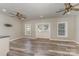 Living room with hardwood floors and ceiling fans and a view to the outside double doors at 159 Badin Lake Cir, New London, NC 28127