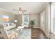 Staged living room with hardwood floors, a ceiling fan, comfortable furniture, and a decorative rug at 159 Badin Lake Cir, New London, NC 28127