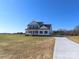 Two-story farmhouse with white siding, black accents, and a long driveway at 1187 Philbeck Rd # 13, York, SC 29745