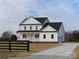 Two-story farmhouse with white siding, black accents, and a wraparound porch at 1187 Philbeck Rd # 13, York, SC 29745