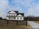 Two-story farmhouse with white siding, black accents, and a wraparound porch at 1187 Philbeck Rd # 13, York, SC 29745