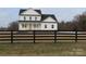 Two-story farmhouse behind a wooden fence, offering privacy and curb appeal at 1187 Philbeck Rd # 13, York, SC 29745