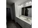 Double vanity bathroom with a large mirror and grey tile floor at 5033 Falstone Dr, Charlotte, NC 28269