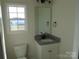 Bathroom with granite countertop, white cabinets, and a large mirror at 1169 Philbeck Rd # 12, York, SC 29745