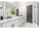 Bright bathroom featuring double vanity, modern fixtures, white cabinets and marble flooring at 3945 Plainview Rd, Charlotte, NC 28208