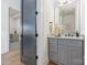 Elegant bathroom featuring gray cabinets, modern fixtures, and a quartz countertop at 3945 Plainview Rd, Charlotte, NC 28208