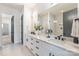 Stylish bathroom featuring a double vanity with modern fixtures and a large mirror at 3945 Plainview Rd, Charlotte, NC 28208