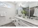 The bright bathroom has double sinks, modern fixtures, and stylish gray tile flooring at 3945 Plainview Rd, Charlotte, NC 28208