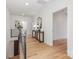 Upstairs hallway featuring wood floors, natural light, and a decorative console table at 3945 Plainview Rd, Charlotte, NC 28208