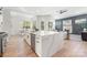 Spacious kitchen featuring white cabinets, stainless steel appliances, quartz countertops and a large island at 3945 Plainview Rd, Charlotte, NC 28208