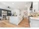 Modern white kitchen featuring stainless steel appliances, sleek cabinetry and quartz countertops at 3945 Plainview Rd, Charlotte, NC 28208