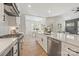 Bright kitchen with stainless steel appliances, quartz countertops and modern white cabinetry throughout at 3945 Plainview Rd, Charlotte, NC 28208