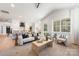 Open-concept living room featuring modern decor, a vaulted ceiling, and seamless flow into the kitchen at 3945 Plainview Rd, Charlotte, NC 28208