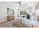 Stylish main bedroom featuring a tray ceiling, large windows and modern furnishings with a neutral palette at 3945 Plainview Rd, Charlotte, NC 28208