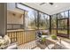 A screened porch provides a relaxing outdoor living area with comfortable seating and natural light at 3945 Plainview Rd, Charlotte, NC 28208