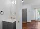 View of a stylish half-bathroom with wood floors and a modern sink at 5535 Whispering Wind Ln, Indian Trail, NC 28079