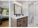 Bathroom featuring vanity with granite counters, wood cabinets and modern fixtures at 5535 Whispering Wind Ln, Indian Trail, NC 28079