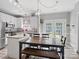 Bright eat-in kitchen with white cabinets, an island, and a view of the backyard at 5535 Whispering Wind Ln, Indian Trail, NC 28079