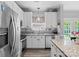 Modern kitchen with stainless steel appliances, granite counters, and white cabinets at 5535 Whispering Wind Ln, Indian Trail, NC 28079