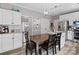 Eat-in kitchen offers stainless appliances, granite countertops, and a lovely breakfast area with light fixture at 5535 Whispering Wind Ln, Indian Trail, NC 28079