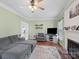 Bright living room features comfortable seating, a fireplace, and an open doorway at 5535 Whispering Wind Ln, Indian Trail, NC 28079
