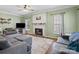 Spacious living room with cozy furniture, a fireplace, and natural lighting at 5535 Whispering Wind Ln, Indian Trail, NC 28079