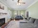 Comfortable living room boasts a fireplace, neutral colors, and ample natural light at 5535 Whispering Wind Ln, Indian Trail, NC 28079