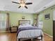 Spacious main bedroom with a ceiling fan, tray ceilings and two large windows at 5535 Whispering Wind Ln, Indian Trail, NC 28079