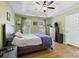 Spacious main bedroom with a ceiling fan, tray ceilings and two large windows at 5535 Whispering Wind Ln, Indian Trail, NC 28079