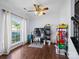 Office with wood floors, ceiling fan, and a large window allowing natural light at 5535 Whispering Wind Ln, Indian Trail, NC 28079