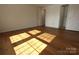 Bright bedroom with wood-look floors and access to bath at 1645 Arlyn Cir # J, Charlotte, NC 28213