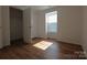 Simple bedroom with wood-look floors and a closet at 1645 Arlyn Cir # J, Charlotte, NC 28213