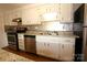 White kitchen cabinets and stainless steel appliances at 1645 Arlyn Cir # J, Charlotte, NC 28213