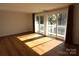 Living room with hardwood floors and access to balcony at 1645 Arlyn Cir # J, Charlotte, NC 28213