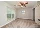 Bright bedroom featuring a large window and ceiling fan at 17810 Half Moon Ln # Q, Cornelius, NC 28031