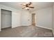 Spacious bedroom with carpet flooring and a ceiling fan at 17810 Half Moon Ln # Q, Cornelius, NC 28031