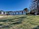 Landscaped lawn with lakefront view and building at 17810 Half Moon Ln # Q, Cornelius, NC 28031