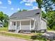 Gray house with a white porch, landscaping, and a spacious yard at 37 Knox St, Salisbury, NC 28144