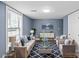 Virtually staged living room featuring light beige sofas and a navy rug at 37 Knox St, Salisbury, NC 28144